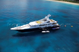 Superyacht at anchor with tenders