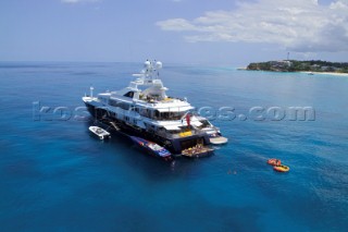 Superyacht at anchor with tenders