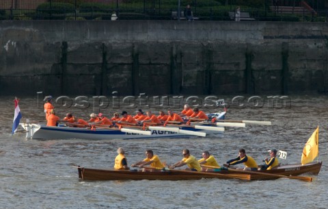 Rowing boats from around Europe compete in the Great River Race down the Thames in London UK