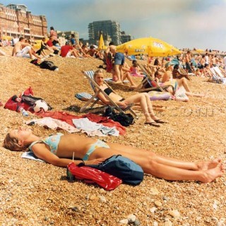 Sunbathers enjoy the summer on a crowded Brighton Beach