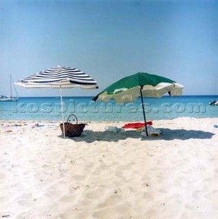 Two parasols on white sandy beach, Corsica