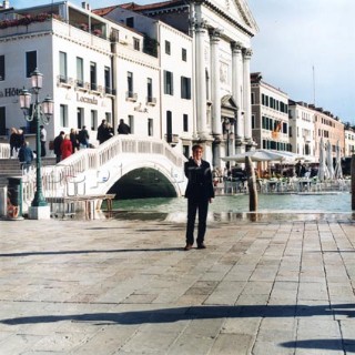 Man standing by bridge in Venice, Italy