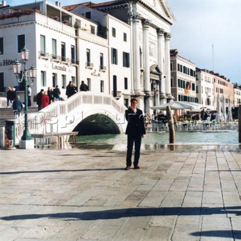 Man standing by bridge in Venice Italy