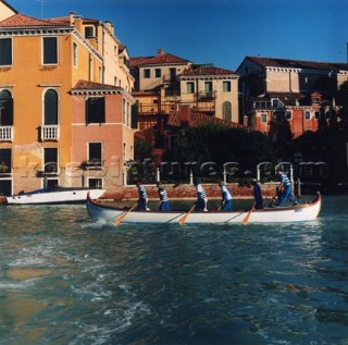 Men rowing along canal in Venice