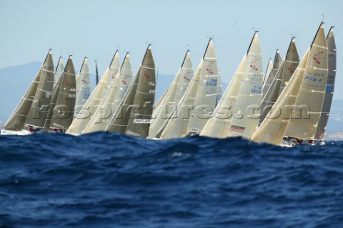 Mumm 30 World Championship 2003 Fleet on the startline behind waves