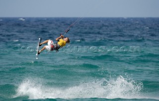 Kitesurfer gets air off a wave in strong breeze