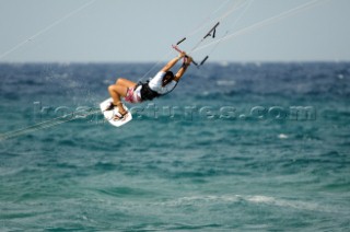 Kitesurfer tangled in kite lines in mid air