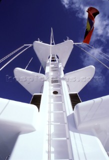 Ladder leading up the communications and signal mast of a superyacht flying courtesy flag