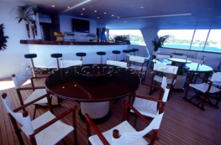 Dining and relaxation seating area. Flavio  Briatore Managing Director of Renault F1 Team France in Viry-Châtillon, on board of his yacht Force Blue. SALES ONLY FOR UK