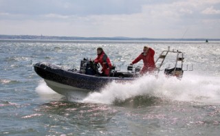 Two men in a rib speedboat with A-frame