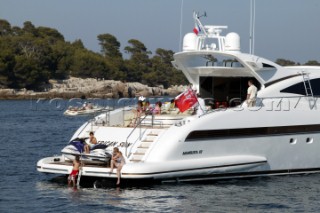 Mangusta powerboat superyacht at anchor in a tranquille bay