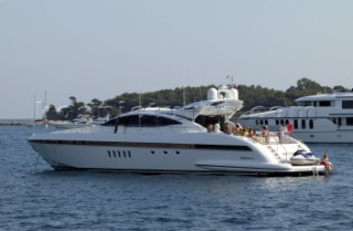 Mangusta powerboat superyacht at anchor in a tranquille bay