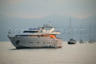 Superyacht at anchor in a tranquille bay