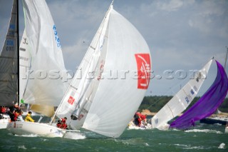 COWES, ENGLAND - AUGUST 1: The French J80 Jackpot sets a spinnaker at the startline of the packed  Sportsboat fleet during Day 4 of Skandia Life Cowes Week 2006. (Photo by Kos/Kos Picture Source via Getty Images)