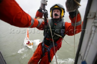 Coastguard preparing to leave Helicopter by winch to aid yacht Innovation in Distress