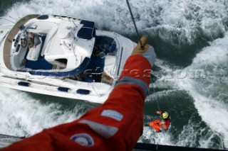 Coastguard being lowered from Helicopter to motor yacht