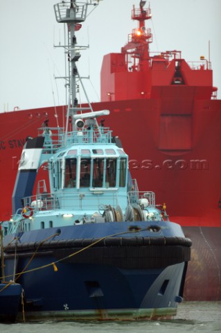 Tug accompanying ocean going cargo vessel