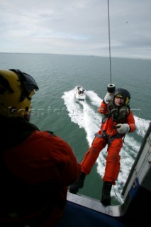 Coastguard Rescue Worker preparing to be winched down from Helicopter