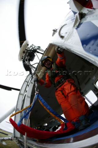 Coastguard Rescue worker in helicopter with rescue harness