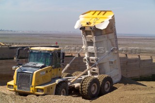 Sea defence building in whitstable kent raising the level of the beach some meters to counter rising sea level and erosion, truck unloading beach infill