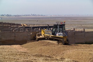 Sea defence building in whitstable kent raising the level of the beach some meters to counter rising sea level and erosion beach infill being laid down with bulldozer
