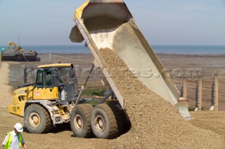 Sea defence building in whitstable kent raising the level of the beach some meters to counter rising sea level and erosion truck unloading beach infill