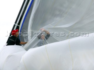 PORTO CERVO, SARDINIA - SEPT 9th 2006: The bowman and foredeck crew of the Wally yacht Tiketitan are smothered by sails during a spinnaker drop during racing in the Maxi Yacht Rolex Cup on September 9th 2006. Tiketitan finished 5th overall in the Wally Division. The Maxi Yacht Rolex Cup is the largest maxi regatta in the world, which attracts the worlds fastest and most expensive sailing yachts to Porto Cervo, Sardinia bi-annually. (Photo by Tim Wright/Kos Picture Source via Getty Images)