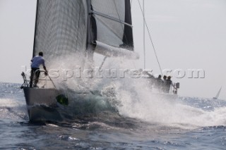 PORTO CERVO, SARDINIA - SEPT 9th 2006: The bowman hangs on to the bow of the Wally yacht Indio (ITA) owned by Andrea Recordati as it crashes through a wave during racing in the Maxi Yacht Rolex Cup on September 9th 2006. Indio finished the regatta 7th overall. The Maxi Yacht Rolex Cup is the largest maxi regatta in the world, which attracts the fastest and most expensive sailing yachts to Porto Cervo, Sardinia bi-annually. (Photo by Tim Wright/Kos Picture Source via Getty Images)