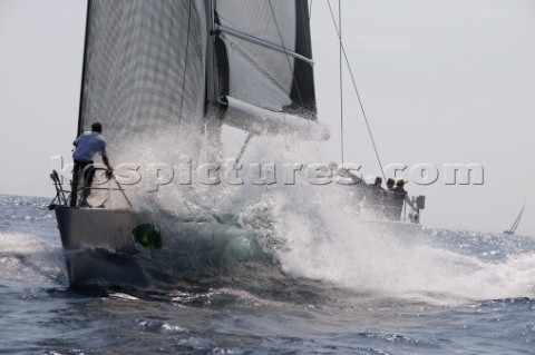 PORTO CERVO SARDINIA  SEPT 9th 2006 The bowman hangs on to the bow of the Wally yacht Indio ITA owne