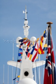 Line of signal flags and pennants on a motor yacht dressed overall