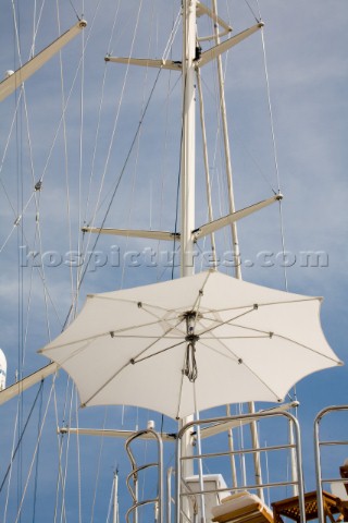 Parasol or umbrella by superyacht masts in the sun