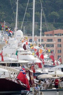 Flags, Ensigns (mostly British) and pennants and courtesy flags on superyachts dressed overall moored stern to in a line in Monaco