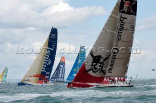PORTSMOUTH, UNITED KINGDOM - MAY 29: The Volvo 70 fleet cross the startline of the inshore race between Legs 7 & 8. In the foreground, Pirates of the Caribbean, skippered by American Paul Cayard, takes an early lead after a favourable windshift on the first leg. ABN AMRO 1 wins the race after Cayard blows it his spinnaker. The Volvo Ocean Race 2005-2006 fleet race in each port between the long distance legs.