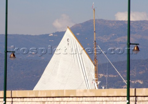 The sail of the yacht Mariquita aeen beyond the sea wall at Les Voiles de Saint Tropez 2005