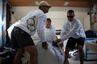 SAINT-TROPEZ, FRANCE - October 5th: The crew onboard the Wally maxi yacht Dangerous But Fun of Monaco owned by Michelle Perris down below inside the yacht re-packing the giant spinnaker during racing on October 5th 2006. It is vital to ensure the spinnaker is not twisted when it is hoisted as this will stop the yacht. Dangerous But Fun crossed the finish in 2nd place. The largest classic and modern yachts from around the world gather in Saint-Tropez annually for a week of racing and festivities to mark the end of the Mediterranean season, before heading across the Atlantic to winter in the Caribbean.