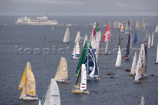 ST. MALO, FRANCE - OCTOBER 29th 2006: The Open 60 trimarans and monohull classes are watched by crowds of spectators as they start the Route du Rhum trans-atlantic race off St. Malo, France, on October 29th. The Route du Rhum is a challenging race for solo sailors which starts in St Malo and finishes in Pointe a Pitre, Guadeloupe. (Photo by Gilles Martin-Raget/Kos Picture Source via Getty Images)