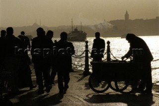 Turkey - People silhouetted against a river scene along the Bosphorus on a cool evening
