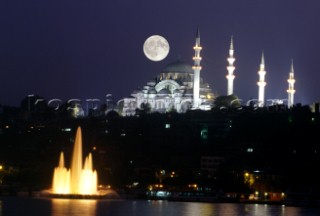 Turkey . Istanbul - The moon rises above a mosque
