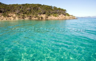 Clear shallow water in a bay with headland beyond