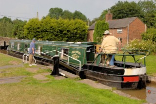 Passing through the lower locks at Grindley Brook,Llangollen canal,Whitchurch,Shropshire,England.July 2006.