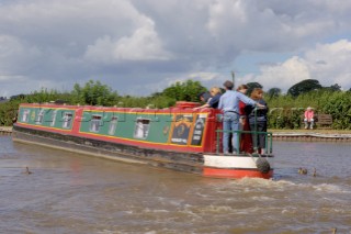 People on narrow boat on the Llangollen canal at Ellesmere,Shropshire,England.