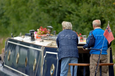 Couple on narrow boatLlangollen canalBettisfieldClwydWalesAugust 2006