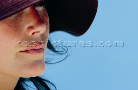Closeup of ladys face shaded by a floppy hat