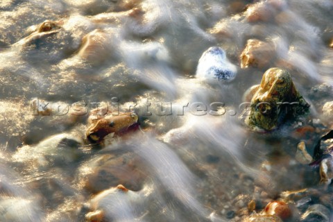 Water flowing over a bed of pebbles