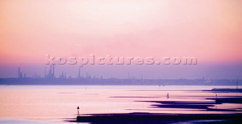 A pink sunset over an industrial skyline
