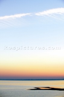 Colourful sunset over a flat calm sea