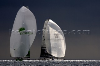 Silhouette of AC yachts sailing downwind