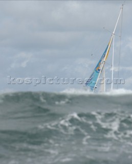 Yacht passes behind a wave in rough seas -  Rolex Fastnet Race 2007