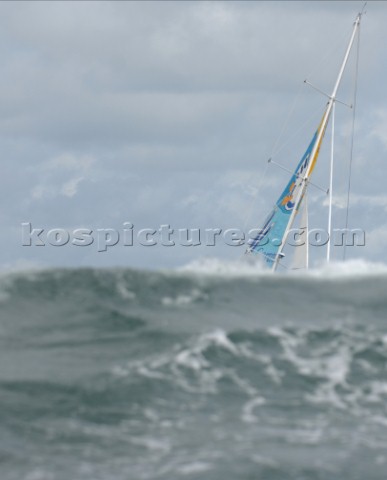 Yacht passes behind a wave in rough seas   Rolex Fastnet Race 2007