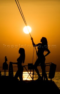 Glamorous female lifestyle model onboard a sailing yacht in the Mediterranean